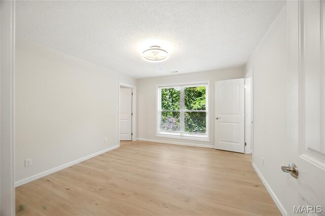 6905 Scenic View Dr, Cedar Hill, MO 63016 - unfurnished room with light wood-style floors and a textured ceiling