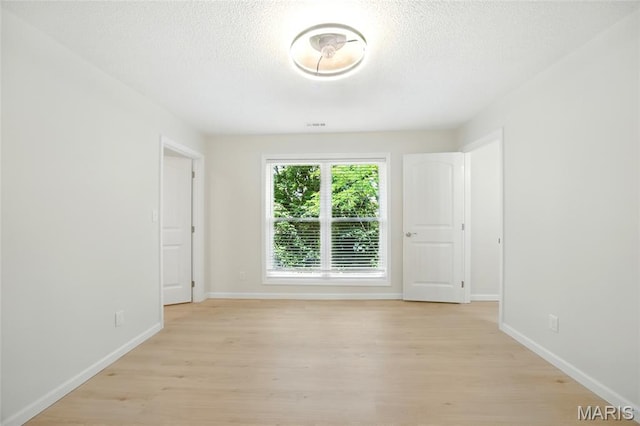 6905 Scenic View Dr, Cedar Hill, MO 63016 - empty room with light wood-style floors and a textured ceiling