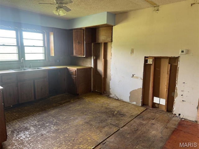 340 S Kitchen St, Dexter, MO 63841 - kitchen featuring a textured ceiling, ceiling fan, light countertops, and wood finished floors