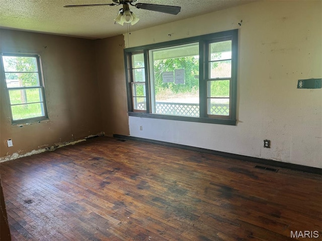 340 S Kitchen St, Dexter, MO 63841 - empty room with ceiling fan, hardwood / wood-style floors, plenty of natural light, and a textured ceiling