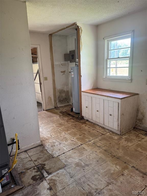 340 S Kitchen St, Dexter, MO 63841 - bathroom featuring gas water heater and a textured ceiling