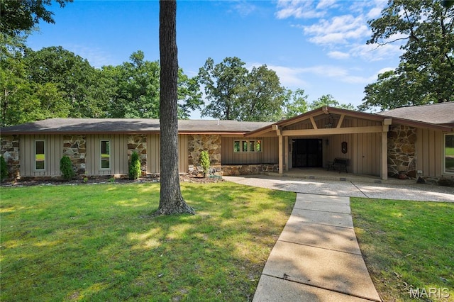 2402 Ripley Rte Unit A, Doniphan, MO 63935 - view of front facade featuring stone siding, a front lawn, board and batten siding, and a shingled roof