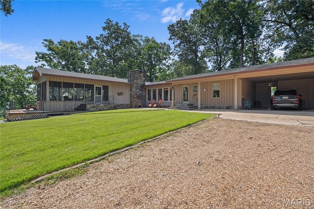 2402 Ripley Rte Unit A, Doniphan, MO 63935 - view of front of home with dirt driveway, board and batten siding, a sunroom, a front lawn, and a chimney