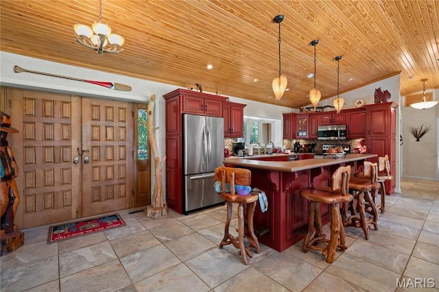 2402 Ripley Rte Unit A, Doniphan, MO 63935 - kitchen with stainless steel appliances, wood ceiling, reddish brown cabinets, lofted ceiling, and backsplash
