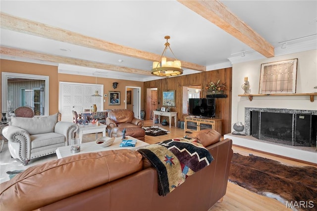 2402 Ripley Rte Unit A, Doniphan, MO 63935 - living room with beamed ceiling, light wood-style flooring, a premium fireplace, wooden walls, and a chandelier