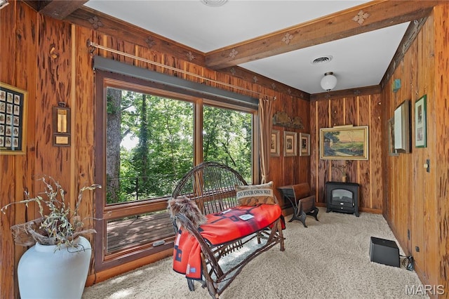 2402 Ripley Rte Unit A, Doniphan, MO 63935 - sitting room featuring a wood stove, carpet floors, wooden walls, and beamed ceiling