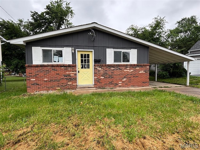 348 Mill St, Bethalto, IL 62010 - bungalow-style home with brick siding, a carport, board and batten siding, and concrete driveway