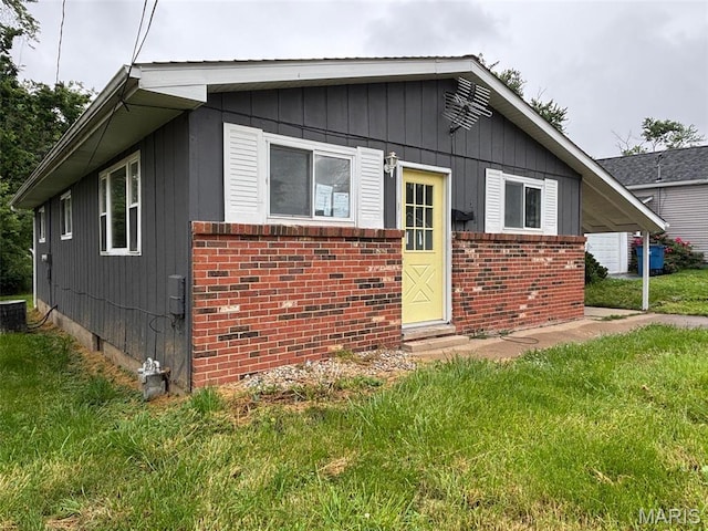 348 Mill St, Bethalto, IL 62010 - bungalow-style house with a front yard, brick siding, and entry steps