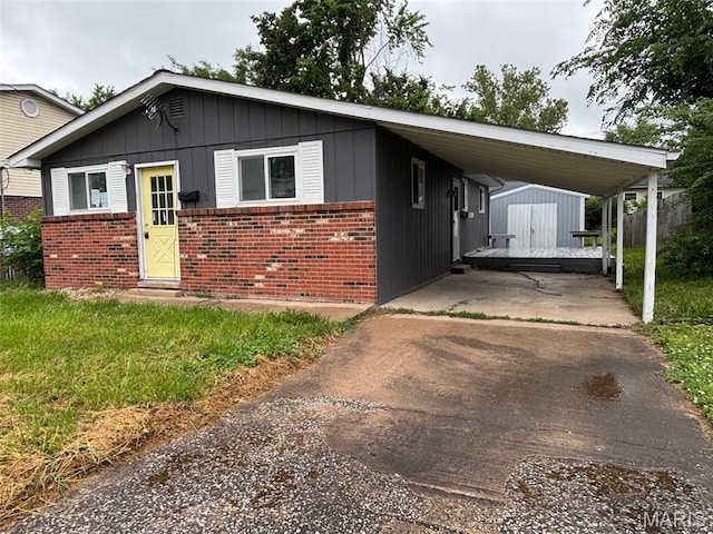 348 Mill St, Bethalto, IL 62010 - view of front facade with brick siding, concrete driveway, a shed, and a carport