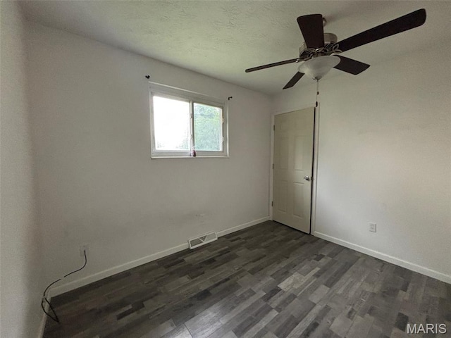 348 Mill St, Bethalto, IL 62010 - spare room featuring dark wood-type flooring and ceiling fan