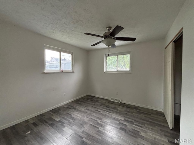 348 Mill St, Bethalto, IL 62010 - unfurnished bedroom with dark wood finished floors, a closet, ceiling fan, and a textured ceiling