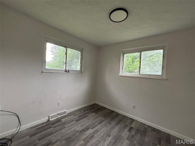 348 Mill St, Bethalto, IL 62010 - unfurnished room featuring healthy amount of natural light, wood finished floors, and a textured ceiling