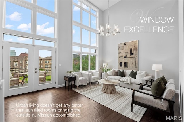 110 N Newstead Ave Unit 303, Saint Louis, MO 63108 - living room with a towering ceiling, a chandelier, plenty of natural light, and dark wood-style flooring