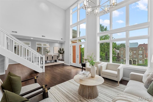 110 N Newstead Ave Unit 303, Saint Louis, MO 63108 - living room with a chandelier, a towering ceiling, and wood finished floors
