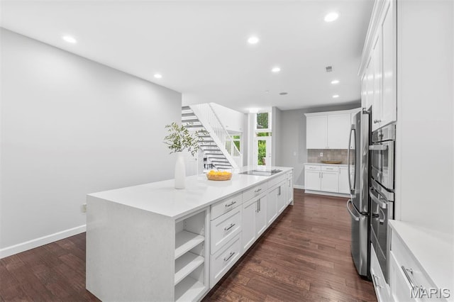 110 N Newstead Ave Unit 303, Saint Louis, MO 63108 - kitchen featuring recessed lighting, backsplash, stainless steel appliances, a center island, and white cabinets
