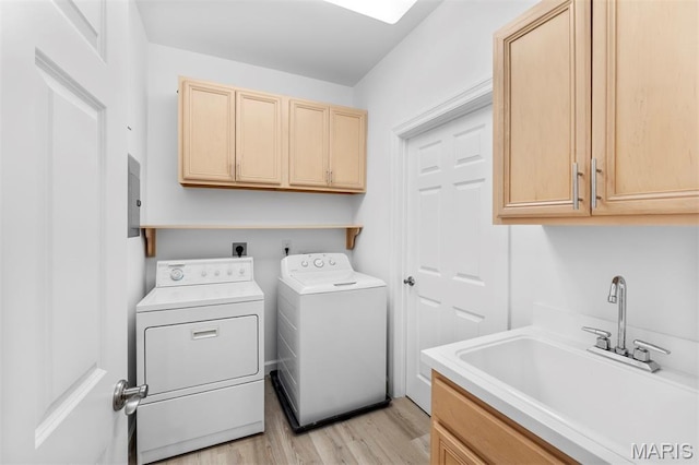 110 N Newstead Ave Unit 303, Saint Louis, MO 63108 - laundry area featuring cabinet space, washer and clothes dryer, and light wood-type flooring