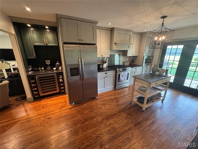 1311 W Line St, Palmyra, MO 63461 - kitchen featuring stainless steel appliances, dark countertops, backsplash, wine cooler, and a chandelier
