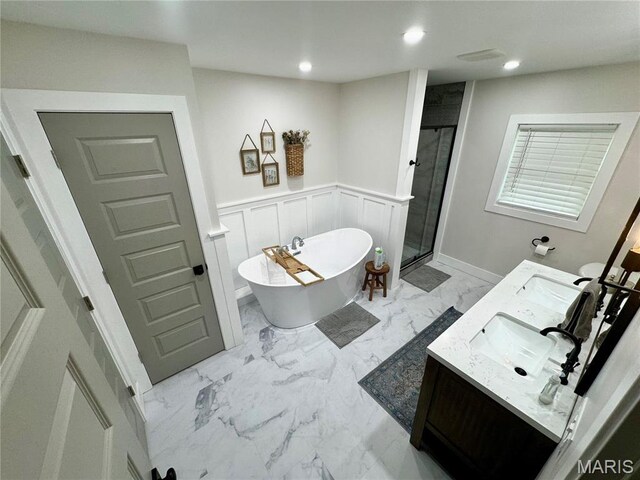 1311 W Line St, Palmyra, MO 63461 - bathroom with marble finish flooring, double vanity, a soaking tub, a stall shower, and recessed lighting