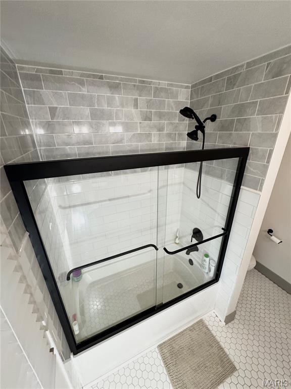 1311 W Line St, Palmyra, MO 63461 - full bathroom featuring shower / bath combination with glass door and tile patterned flooring