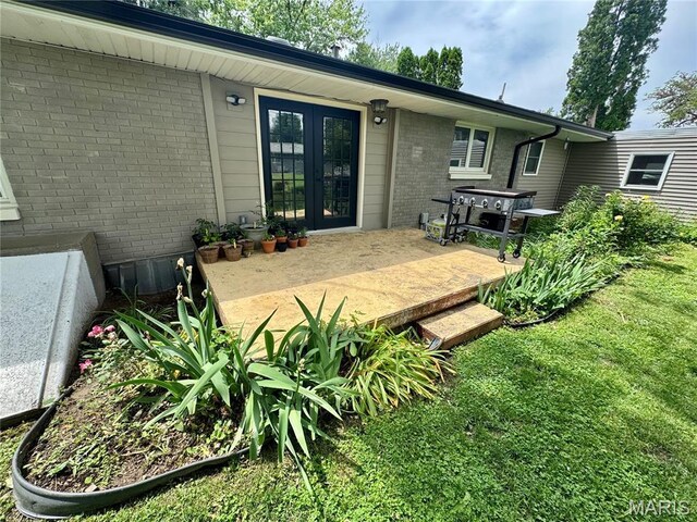 1311 W Line St, Palmyra, MO 63461 - rear view of house with brick siding, french doors, a lawn, and a deck