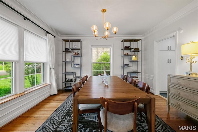 8140 Pershing Ave, Clayton, MO 63105 - dining area with a chandelier, light wood-style floors, and crown molding
