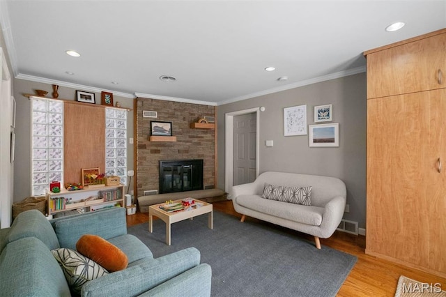 8140 Pershing Ave, Clayton, MO 63105 - living area featuring light wood finished floors, recessed lighting, crown molding, and a fireplace