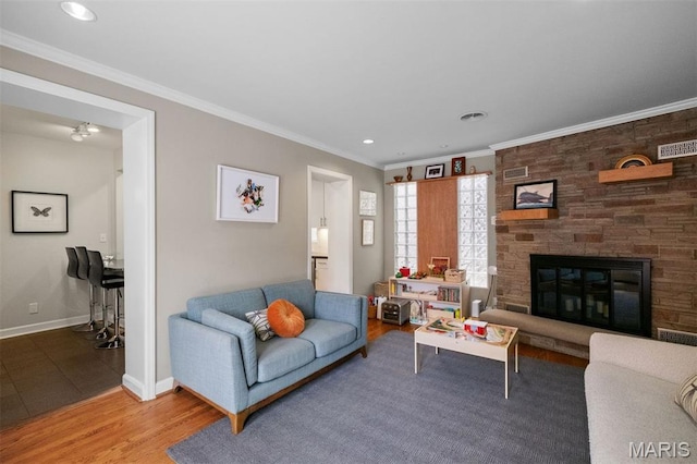 8140 Pershing Ave, Clayton, MO 63105 - living room with a fireplace, wood finished floors, ornamental molding, and recessed lighting