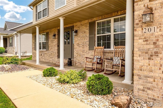 201 Mcclelland Dr, Troy, IL 62294 - view of exterior entry featuring a porch and brick siding