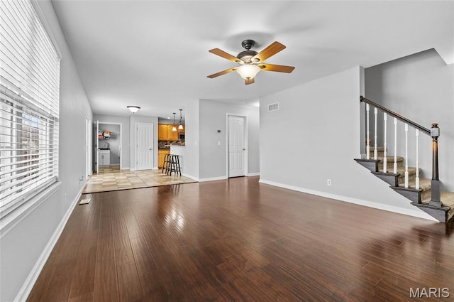 201 Mcclelland Dr, Troy, IL 62294 - unfurnished living room featuring a ceiling fan, stairs, and wood finished floors