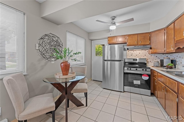 9003 Villaridge Ct Unit A, Affton, MO 63123 - kitchen with stainless steel appliances, under cabinet range hood, brown cabinets, tasteful backsplash, and light countertops