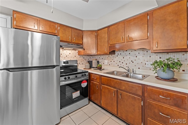 9003 Villaridge Ct Unit A, Affton, MO 63123 - kitchen featuring stainless steel appliances, under cabinet range hood, brown cabinetry, light tile patterned floors, and light countertops