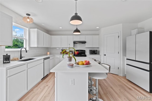 1549 Cascade Ln, Eureka, MO 63025 - kitchen with freestanding refrigerator, dishwasher, under cabinet range hood, light countertops, and recessed lighting