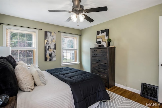 7041 Plainview Ave, Saint Louis, MO 63109 - bedroom with wood finished floors, multiple windows, and a ceiling fan