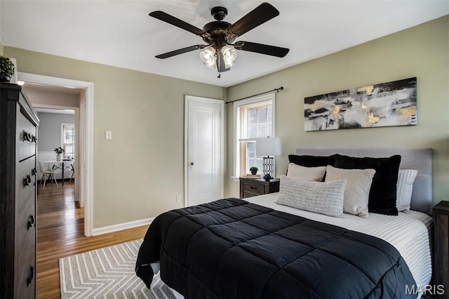7041 Plainview Ave, Saint Louis, MO 63109 - bedroom featuring wood finished floors, multiple windows, and ceiling fan