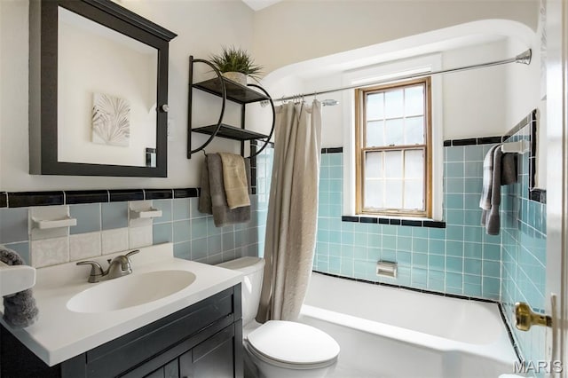 7041 Plainview Ave, Saint Louis, MO 63109 - bathroom with tile walls, vanity, shower / tub combo, and wainscoting