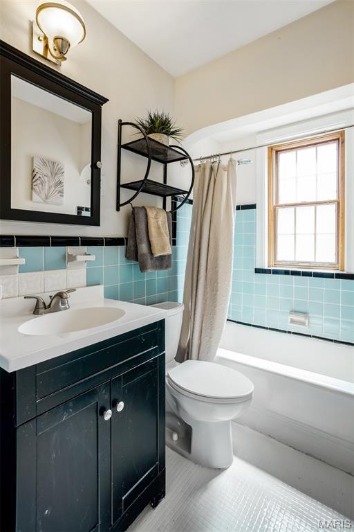 7041 Plainview Ave, Saint Louis, MO 63109 - full bath with vanity, tile walls, shower / bath combination with curtain, tile patterned flooring, and decorative backsplash