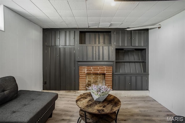 7041 Plainview Ave, Saint Louis, MO 63109 - living area featuring wood finished floors, wood walls, and a brick fireplace