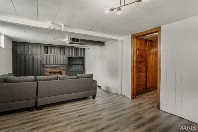 7041 Plainview Ave, Saint Louis, MO 63109 - living room with wood finished floors and a brick fireplace