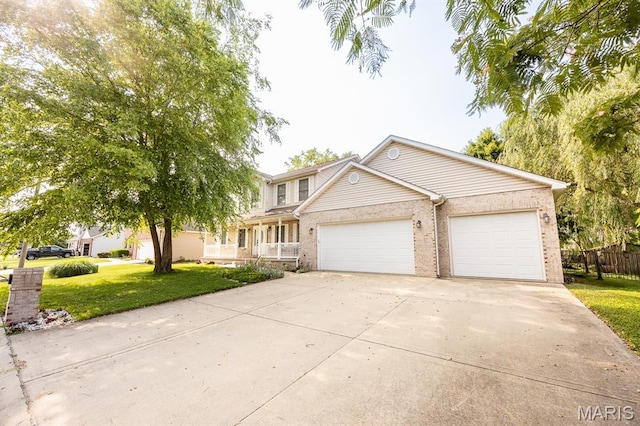 1241 Antique Ln, Mascoutah, IL 62258 - traditional-style house with an attached garage, driveway, brick siding, and covered porch