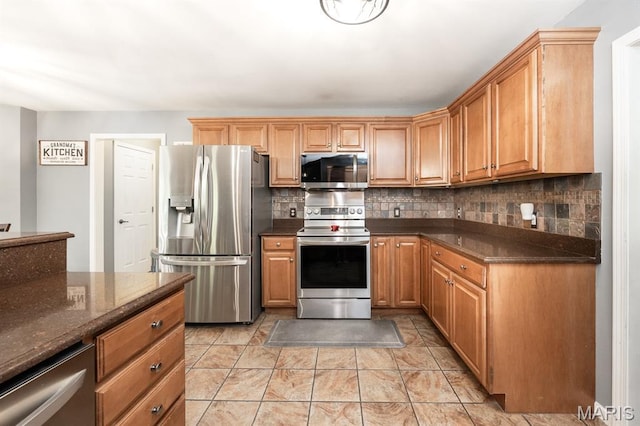 1241 Antique Ln, Mascoutah, IL 62258 - kitchen with stainless steel appliances, decorative backsplash, and dark stone counters