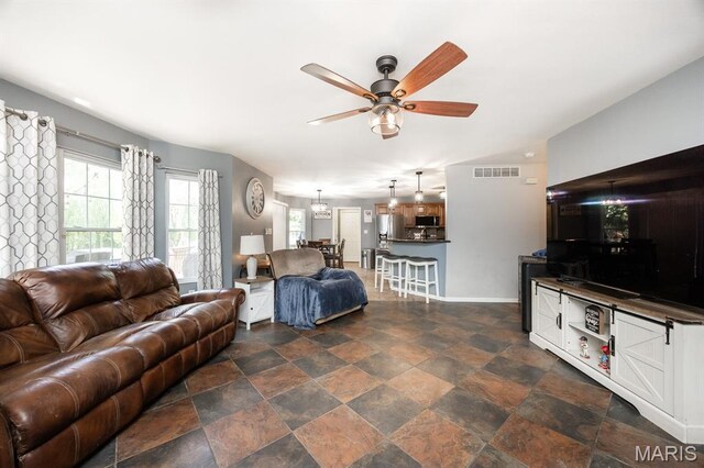 1241 Antique Ln, Mascoutah, IL 62258 - living area with ceiling fan and dark stone finish floors