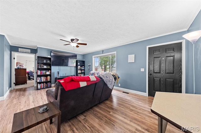 44 Viola Dr, Wright City, MO 63390 - living area featuring light wood-type flooring, a ceiling fan, crown molding, and a textured ceiling