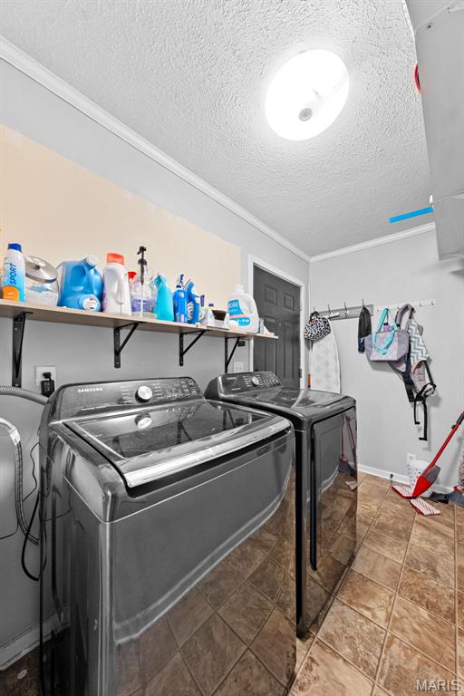 44 Viola Dr, Wright City, MO 63390 - laundry room featuring independent washer and dryer, a textured ceiling, and ornamental molding