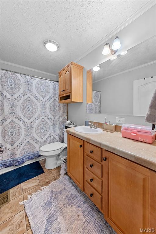 44 Viola Dr, Wright City, MO 63390 - bathroom with vanity, crown molding, a textured ceiling, a shower with shower curtain, and tile patterned floors