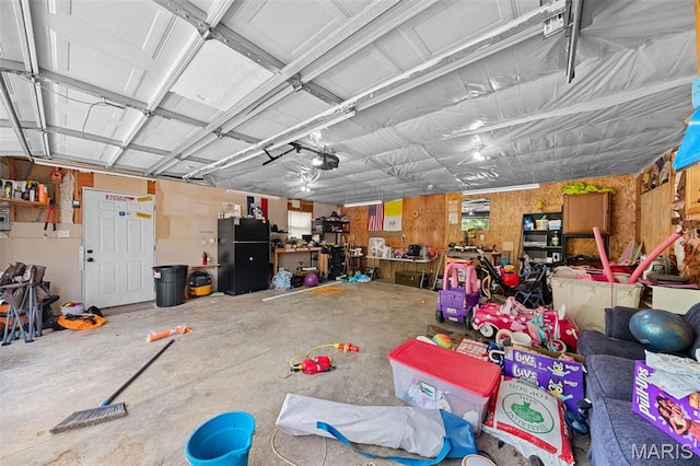 44 Viola Dr, Wright City, MO 63390 - garage featuring freestanding refrigerator and a garage door opener