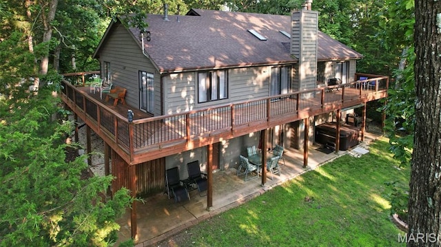 877 Red Fox Dr, Innsbrook, MO 63390 - rear view of property featuring a patio, a wooden deck, a shingled roof, a lawn, and a chimney