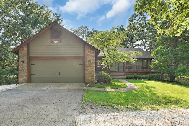 877 Red Fox Dr, Innsbrook, MO 63390 - view of front of house featuring stone siding, asphalt driveway, a front yard, and an attached garage