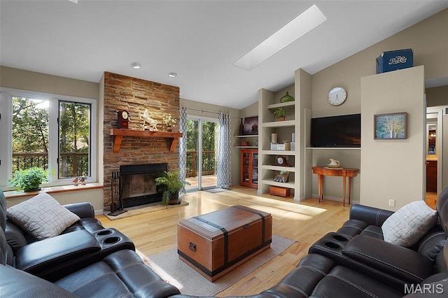 877 Red Fox Dr, Innsbrook, MO 63390 - living room featuring wood finished floors, a fireplace, and high vaulted ceiling