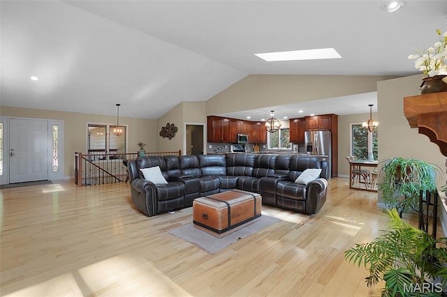 877 Red Fox Dr, Innsbrook, MO 63390 - living room featuring a chandelier, light wood-style flooring, a skylight, high vaulted ceiling, and recessed lighting