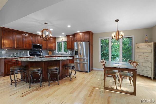 877 Red Fox Dr, Innsbrook, MO 63390 - kitchen featuring a chandelier, appliances with stainless steel finishes, light wood-style floors, and recessed lighting
